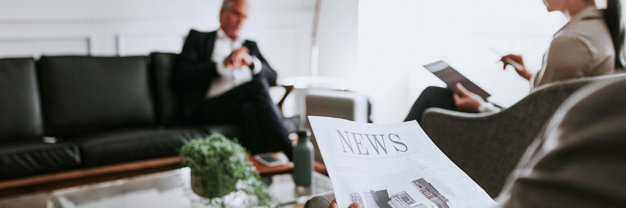 busy businessman reading newspaper lounge